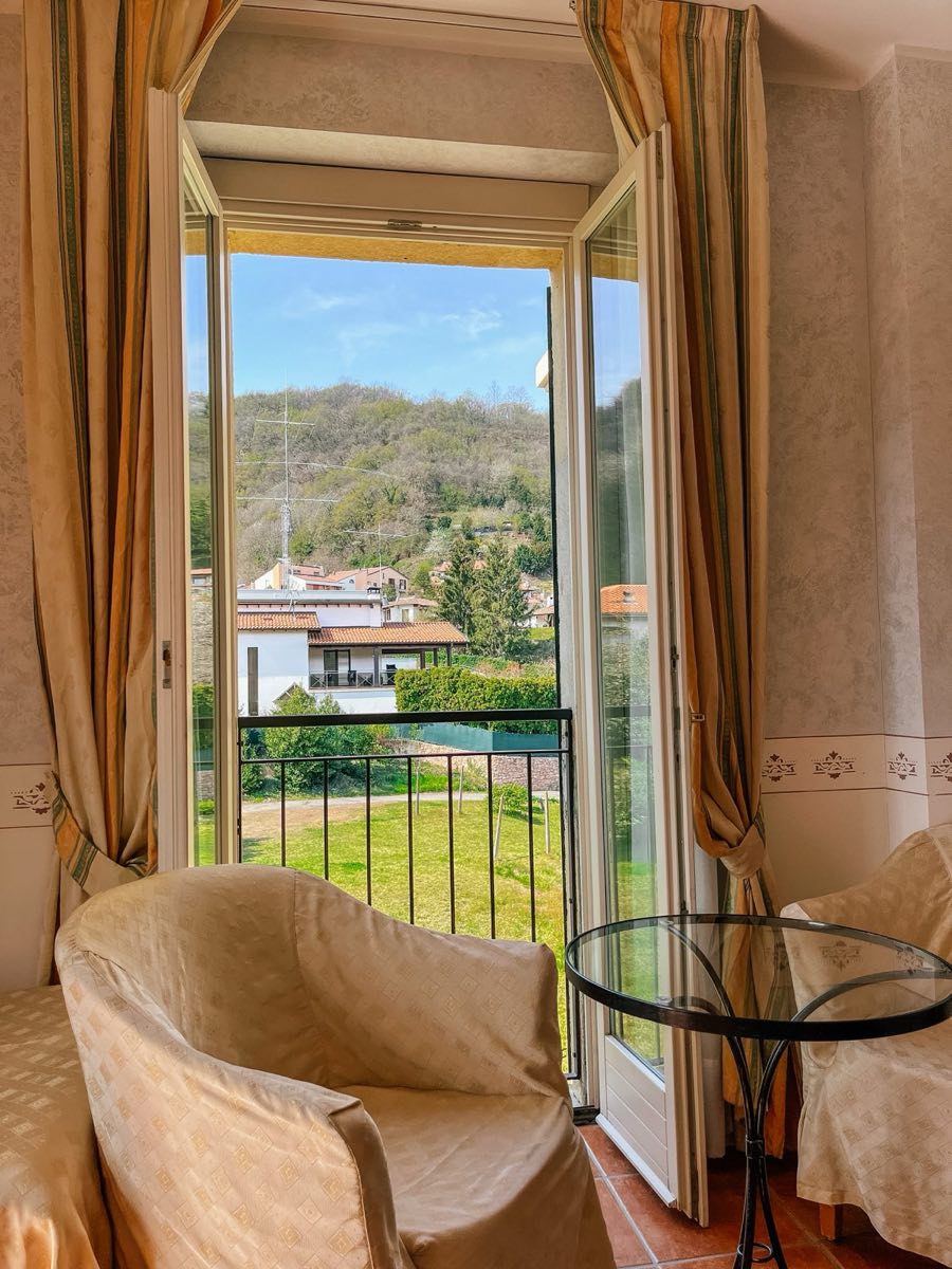 Balcony Room: the open balcony doors, the garden and hills outside