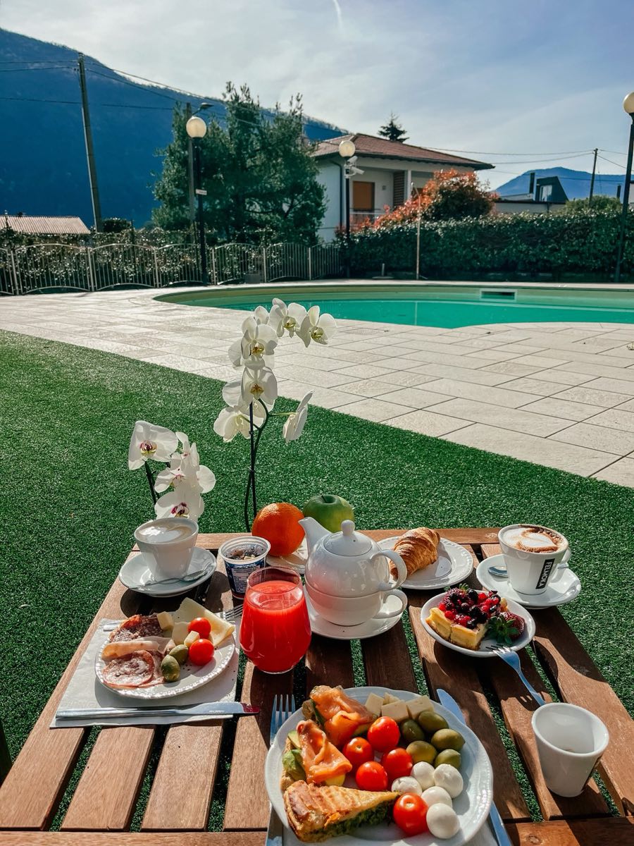 A breakfast table on the lawn by the pool