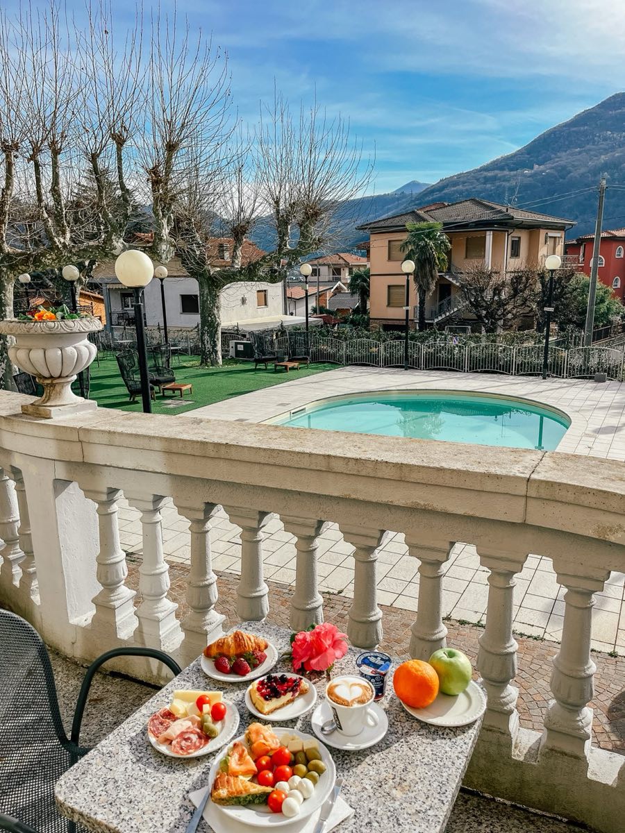 Breakfast on the balustrade above the pool, mountains beyond