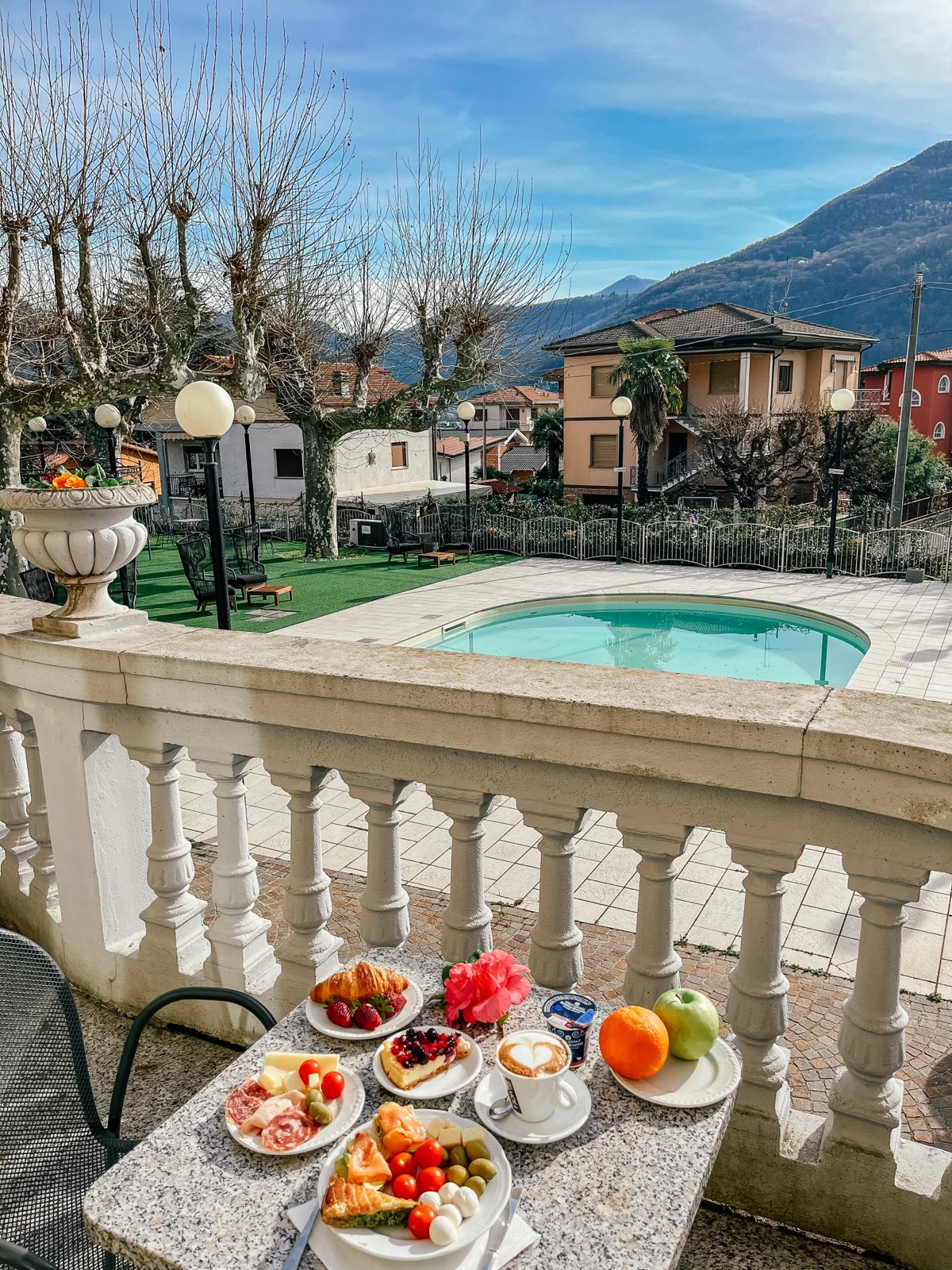 Breakfast laid on the stone balustrade above the pool, the mountains and villas beyond.